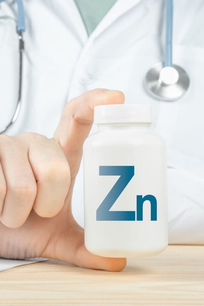 doctor holding zinc supplement bottle